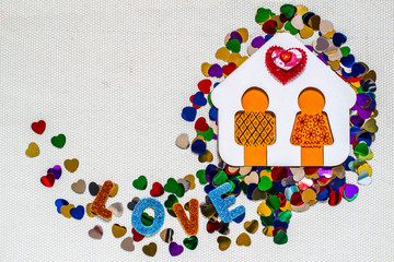 Wooden house with little man and bright confetti heart-shaped