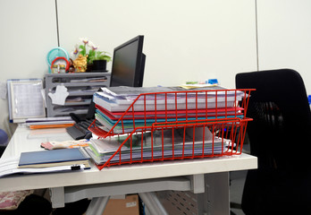  Red  basket of documents on the desk