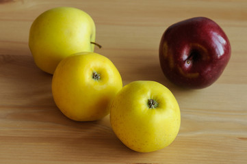 Red and yellow apples in table