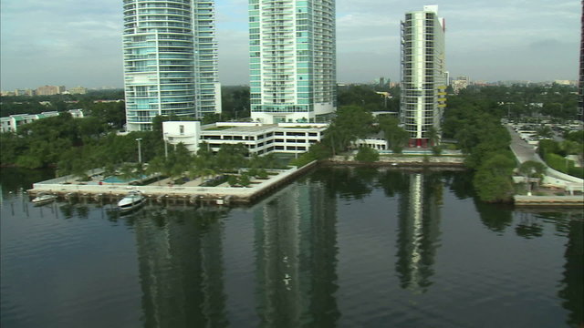 Flying over the water with sights of Miami buildings.