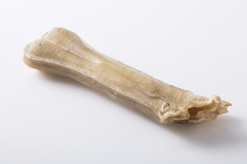 Eaten dog treat bone on background