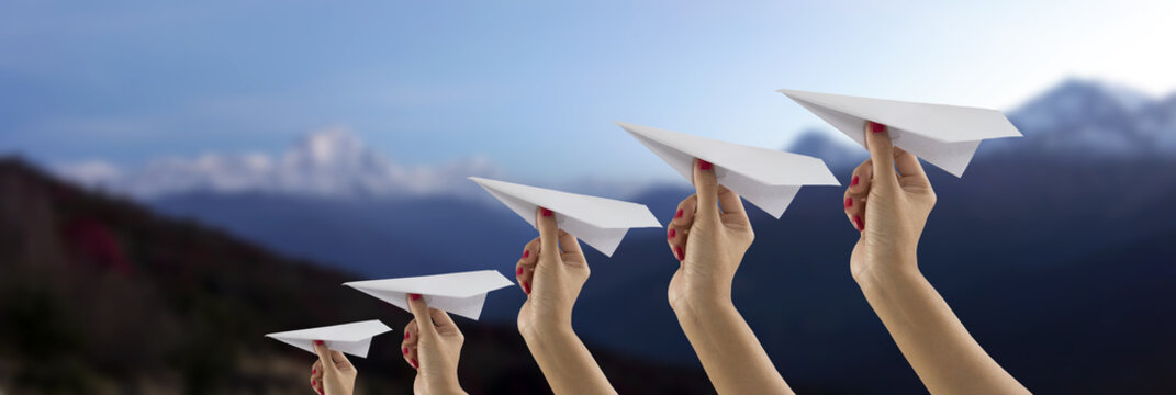 Paper plane holding by hand on Everest mountain view blur backgr