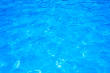 Blue pool water with sun reflections