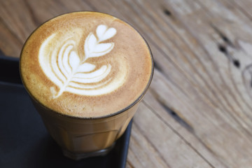 Coffee with heart shape latte art serve in glass