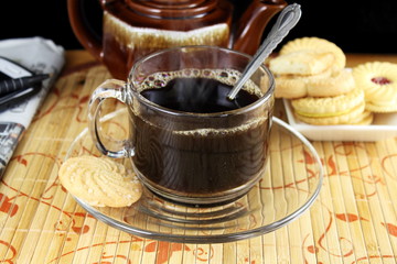 coffee cup with steam and biscuits or cookies closeup
