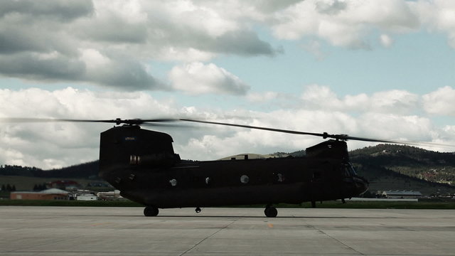 Time-lapse footage of a Chinook helicopter at an airfield.