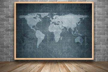 world map on old blueprint background texture in wooden frame in interior room with black brick wall and wooden floor