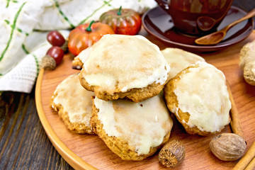 Cookies pumpkin with cup on wooden tray