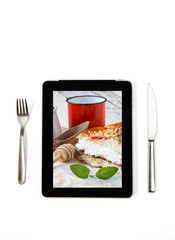 Photo cream cake with grapes on tablet indoors