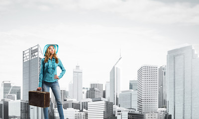 Attractive girl with old suitcase