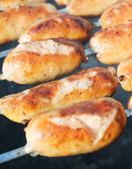 Fried sausages on the grill.