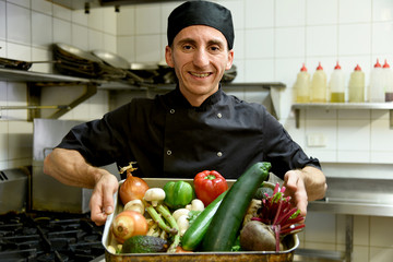 chef holding fresh and healthy vegetables