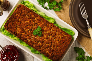 Homemade meat pie with vegetables, served with cranberry sauce