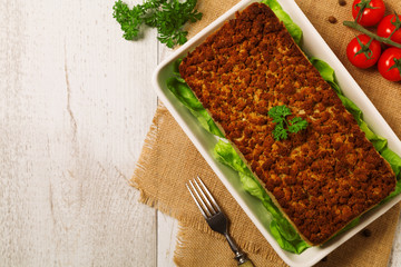 Homemade meat pie with vegetables, served with cranberry sauce
