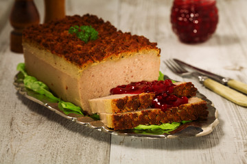 Homemade meat pie with vegetables, served with cranberry sauce