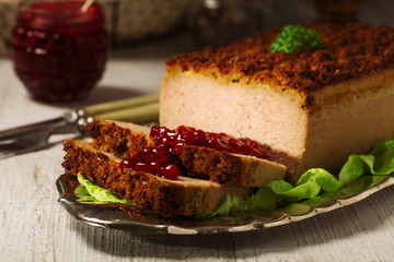 Homemade meat pie with vegetables, served with cranberry sauce