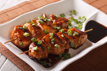 chicken yakitori on skewers close-up on a plate. horizontal

