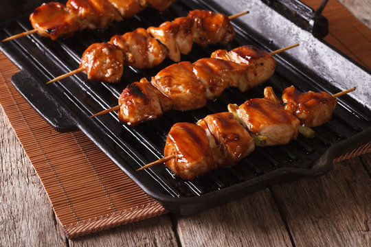 Delicious Japanese yakitori barbecue of chicken on a grill pan. 
