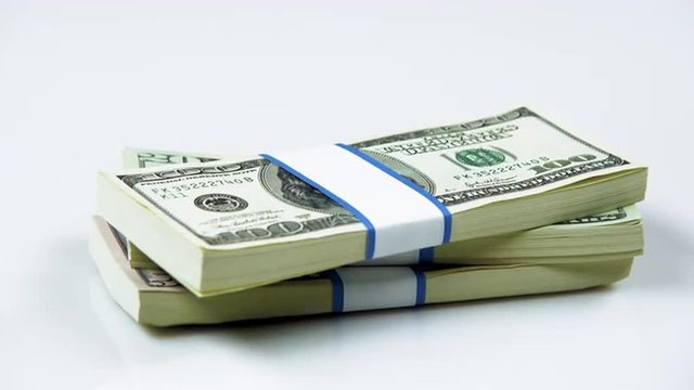 Clip of bundles of American currency appearing.