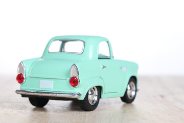 Plakat miniature car on wooden floor isolated on white background
