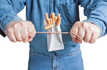 Human hands breaking the pack of cigarettes