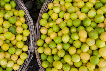 Limes an lemons in two baskets