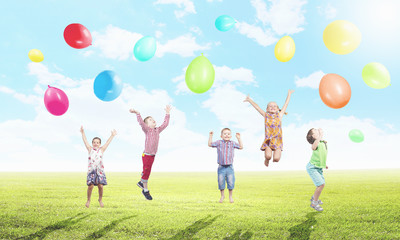 Playful children catch balloons