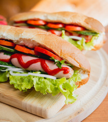 Large hot dog with vegetables