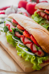 Large hot dog with vegetables