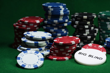 Close up shot of group poker chips on green table
