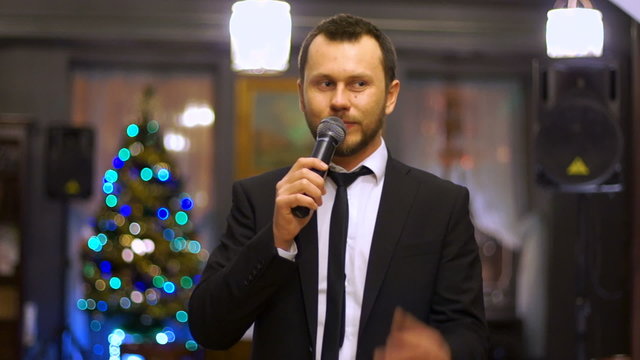 Young presenter speaks into the microphone at the festival