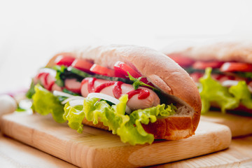 Large hot dog with vegetables