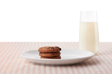 Chocolate chip cookies on plate and glass of milk