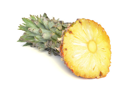 Pineapple and its slices on a white background