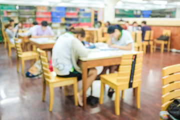 Blurred image of people reading book