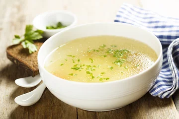 Foto op Plexiglas Chicken broth with herbs © marysckin