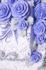 Big white wedding cake decorated with flowers