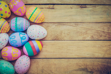 Easter eggs on wooden background with vintage tone.