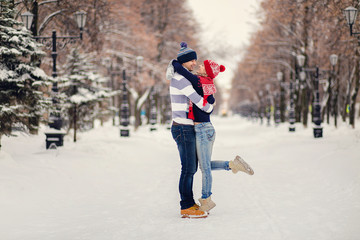 Young couple hugging and kissing in the Park in winter