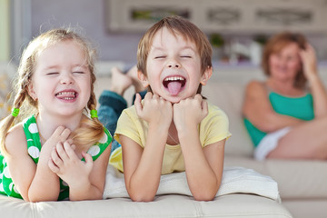 Grandmother are playing with kids at home