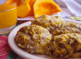 Cutlets meat with pumpkin on a plate, a glass and pumpkin slices