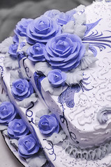 Big white wedding cake decorated with flowers