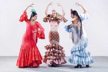 Pretty three young flamenco dancer in beautiful dress. - obrazy, fototapety, plakaty