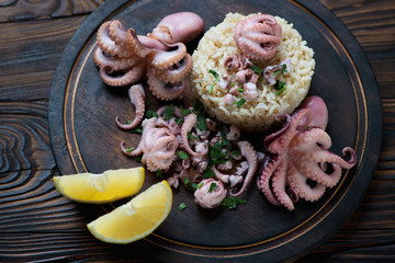Octopuses with brown rice, lemon and fresh parsley, close-up