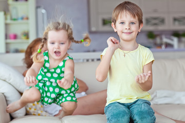 Grandmother are playing with kids at home