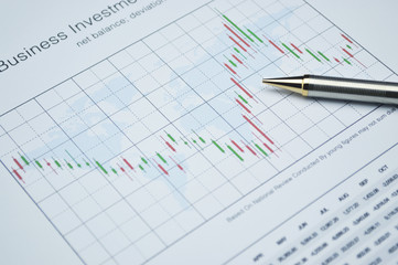 Pencil on stock market graph, financial concept