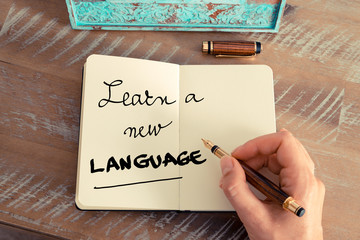 Handwritten text LEARN A NEW LANGUAGE