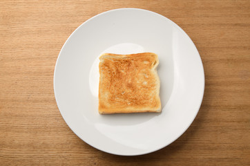 Toasted slice of bread on white plate