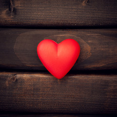 Red heart on the dark boards