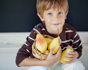 Happy kid with fresh pear 